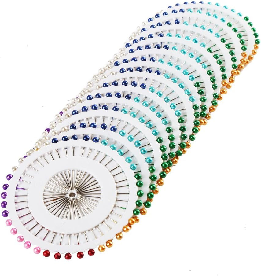 A set of multicolored thread, yarn, and bobbin winders arranged in a spiral on a white background.