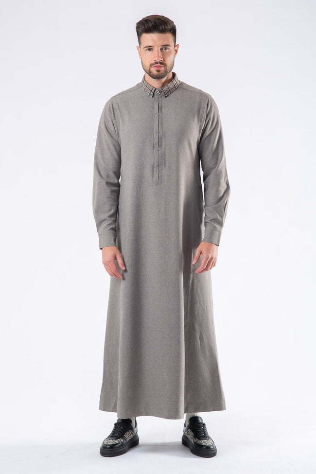 A man wearing a gray Al Ameer traditional thobe with a printed cuff and branded buttons. AAR2420- Al Ameer thobes thobe product image