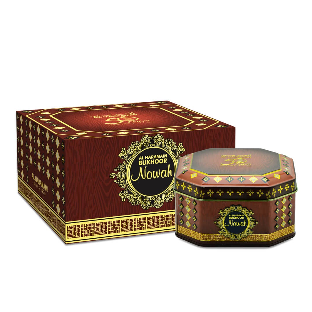 The image shows the packaging of Haramain Bukhoor Nowah, which includes a rectangular box and a round bottle, both with ornate designs and the brand name prominently displayed.