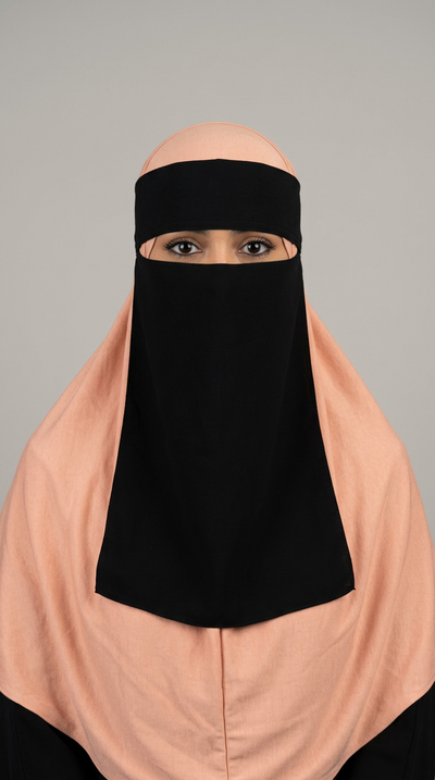 Black Clip Niqab 07 with a peach hijab, front view