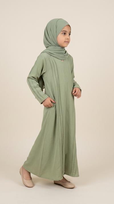 Girl wearing sage green All-Flap abaya and matching hijab