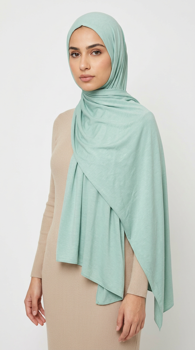 Woman wearing the Turquoise Big Jersey Hijab with a beige top