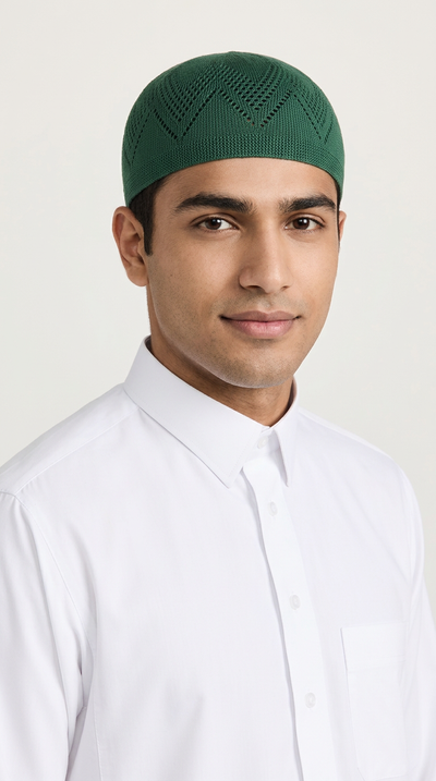 Man wearing a forest green topi prayer cap, front view