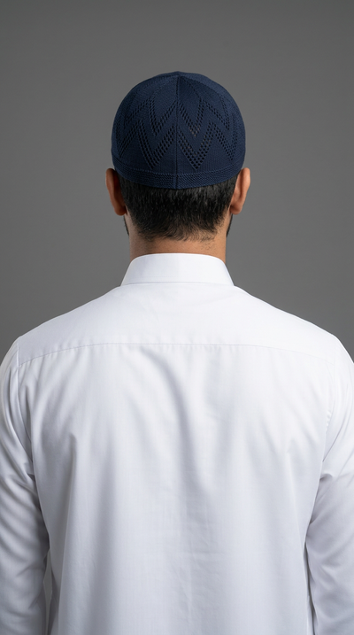 Man wearing a navy topi prayer cap, rear view