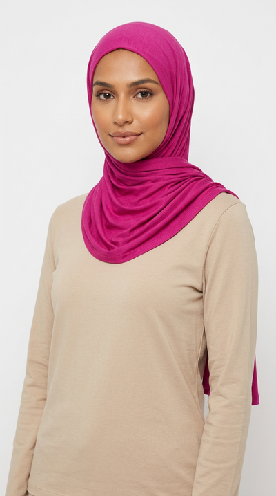 Woman wearing the Magenta Big Jersey Hijab with a beige top