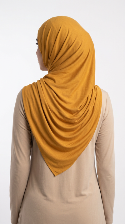 Model wearing a mustard yellow Premium Jersey Hijab, back view