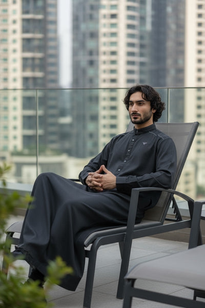 Man sitting on a chair with city skyline in the background