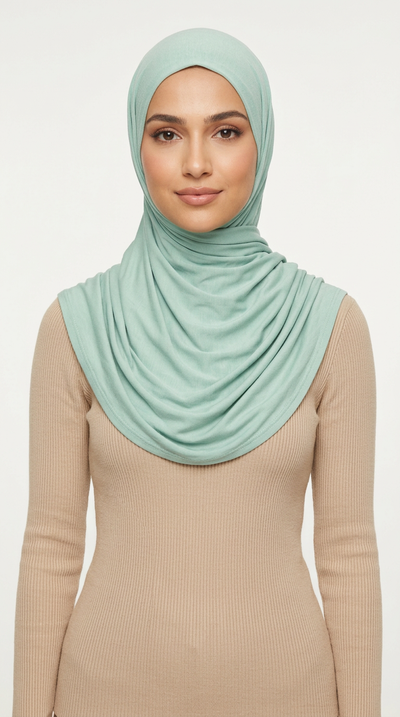 Woman wearing the Turquoise Big Jersey Hijab with a beige top