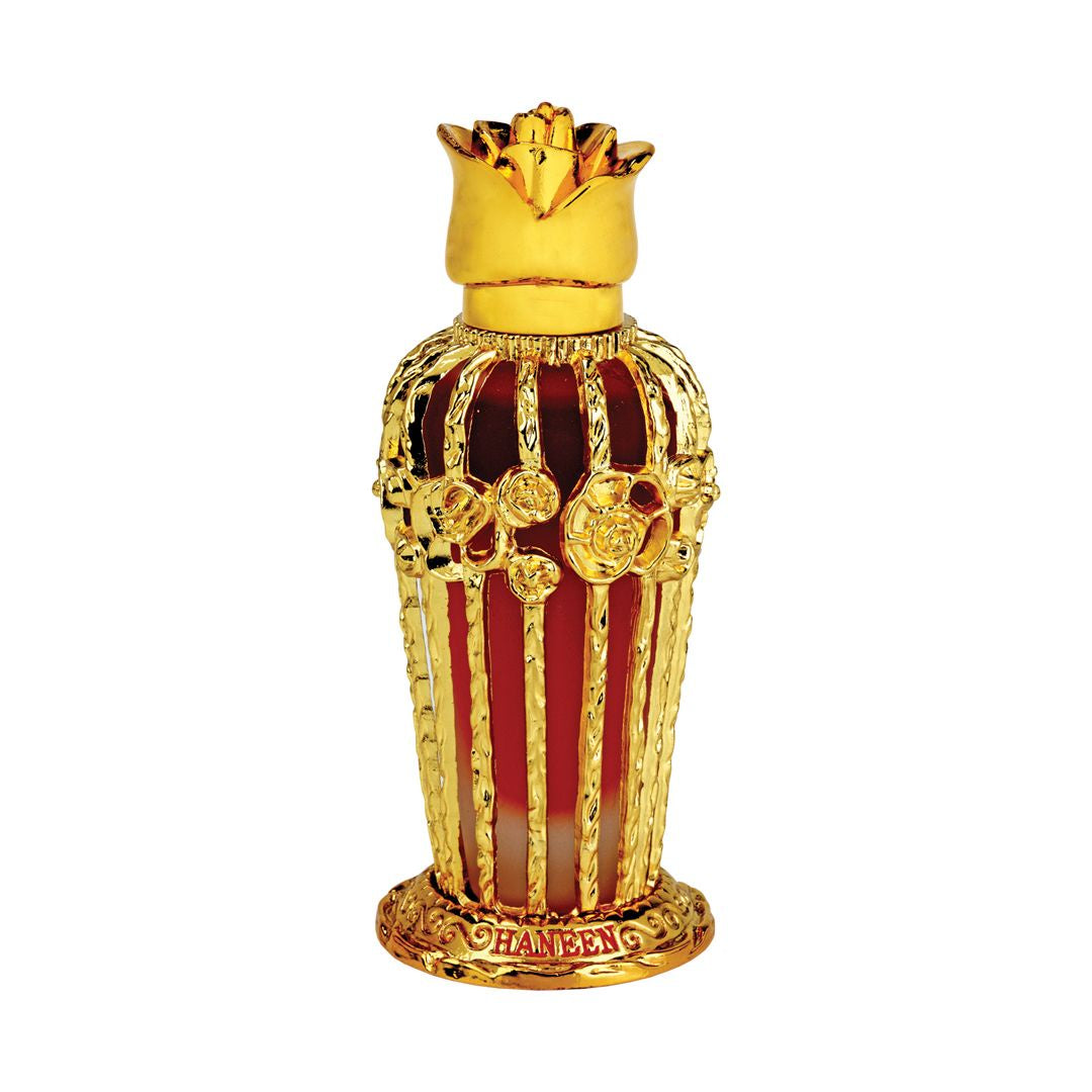 A decorative perfume bottle with a gold-colored cap and red-brown body, featuring intricate designs and floral motifs.
