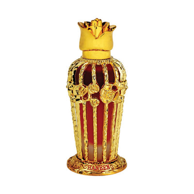 A decorative perfume bottle with a gold-colored cap and red-brown body, featuring intricate designs and floral motifs.