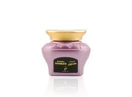 A jar of OUD MUATTAR MAAMUL HANEEN by Khadlaj Perfumes, containing perfumed oud wood chips.