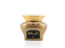 A jar of OUD MUATTAR MAAMUL DAHABI by Khadlaj Perfumes, containing perfumed oud wood chips.