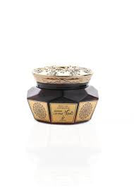 A jar of Oud Moattar Samou Al Oud fragrance with a decorative lid, set against a white background.