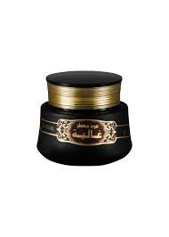 A black and gold colored container of Oud Muattar Ghalia 35 G with Arabic script on the label.