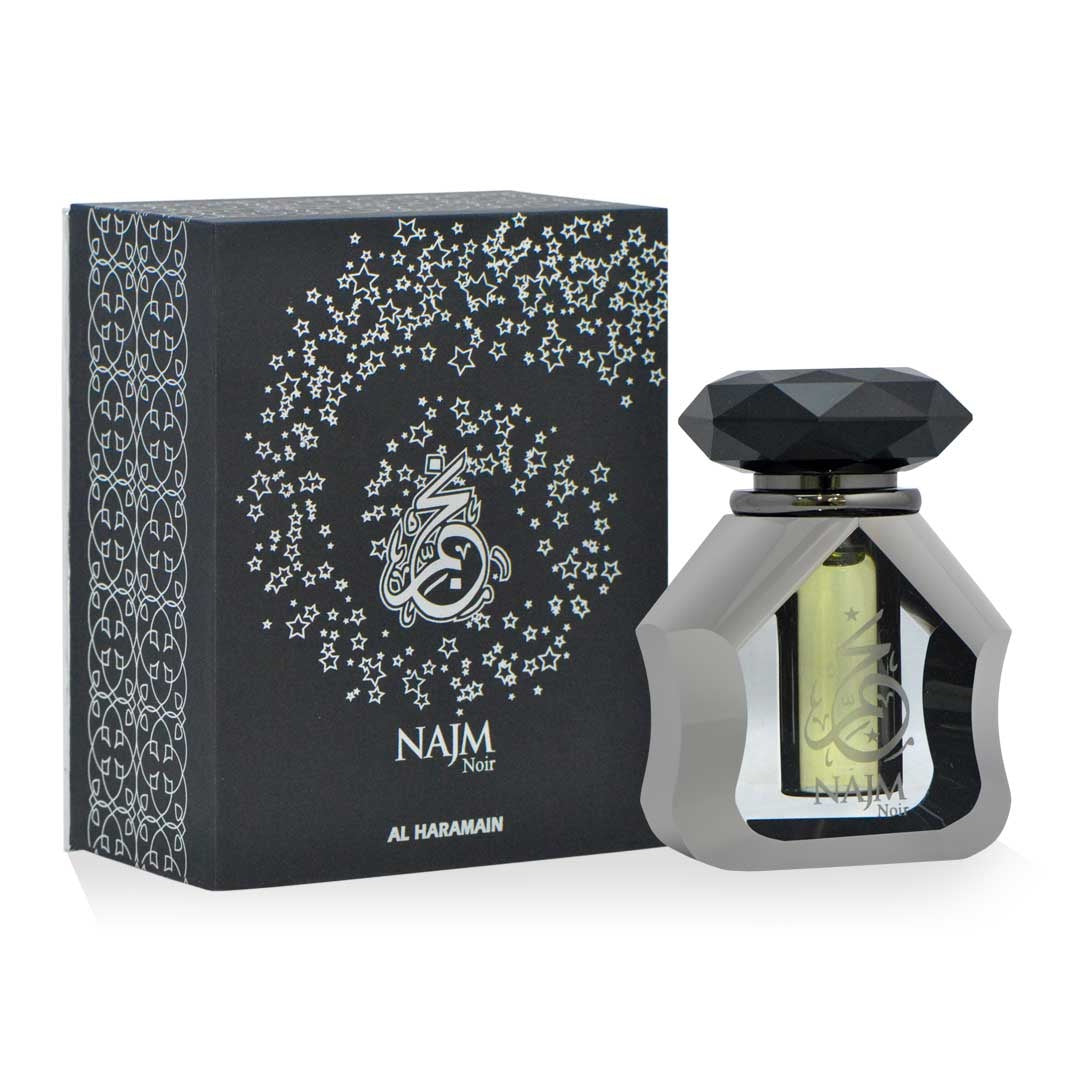 A bottle of Haramain Najm Noir perfume oil with a black and silver design, alongside its black box packaging adorned with silver floral patterns.