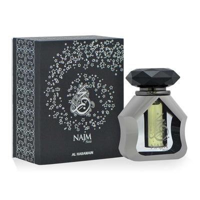 A bottle of Haramain Najm Noir perfume oil with a black and silver design, alongside its black box packaging adorned with silver floral patterns.